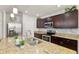 Modern kitchen with granite countertops, stainless steel appliances, and a convenient island at 3065 Timber Hawk Cir, Ocoee, FL 34761
