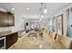 Open-concept kitchen featuring stainless steel appliances, granite countertops, and seamless flow into the living area at 3065 Timber Hawk Cir, Ocoee, FL 34761