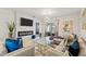 Bright living room featuring a modern fireplace, large TV, and stylish glass coffee table at 3065 Timber Hawk Cir, Ocoee, FL 34761