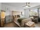 Cozy main bedroom with a tufted headboard, comfortable seating, and ample natural light at 3065 Timber Hawk Cir, Ocoee, FL 34761
