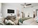 Spacious main bedroom featuring a large TV, sitting area, and access to an ensuite bathroom at 3065 Timber Hawk Cir, Ocoee, FL 34761