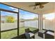 Screened patio with ceiling fan and outdoor seating overlooking a well-maintained fenced backyard at 3065 Timber Hawk Cir, Ocoee, FL 34761