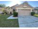 Charming single-story home with a well-maintained lawn and attached two car garage at 3124 Ginger Cir, Orlando, FL 32826