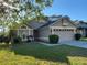 Charming single-story home with a well-maintained lawn and attached two car garage at 3124 Ginger Cir, Orlando, FL 32826