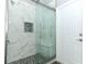 A marble shower with glass doors showcases luxurious details and includes a built-in bench for added convenience at 3200 Town And Country Rd, Oviedo, FL 32766