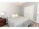 Comfortable bedroom featuring a full bed, gray wood-look flooring, and a double-door closet at 3200 Town And Country Rd, Oviedo, FL 32766