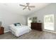 Cozy bedroom with a ceiling fan, a large dresser, and two windows at 3200 Town And Country Rd, Oviedo, FL 32766