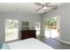 Bedroom featuring a ceiling fan, dresser, and view of the pool from the sliding glass door at 3200 Town And Country Rd, Oviedo, FL 32766