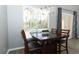Charming dining area with a view of the pool, featuring a wooden table and pendant lighting at 3200 Town And Country Rd, Oviedo, FL 32766