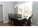 Bright dining area with a view of the pool, featuring a wooden table and chairs with pendant lighting at 3200 Town And Country Rd, Oviedo, FL 32766