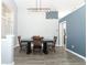 Dining room with hard wood flooring, a dark table, and updated grey colored walls at 3200 Town And Country Rd, Oviedo, FL 32766
