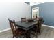 Dining room with hard wood flooring, a dark table, and updated grey colored walls at 3200 Town And Country Rd, Oviedo, FL 32766