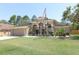Charming single Gathering home with landscaped front yard and attached garage with large lawn and American flag at 3200 Town And Country Rd, Oviedo, FL 32766