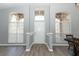 Bright foyer featuring a modern chandelier, high ceilings, and wood-look flooring at 3200 Town And Country Rd, Oviedo, FL 32766