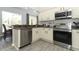 Well-equipped kitchen featuring stainless steel appliances, granite countertops, and wood-look flooring at 3200 Town And Country Rd, Oviedo, FL 32766