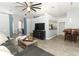 Open-concept living room showcasing wood floors, a ceiling fan, and easy access to the kitchen and dining areas at 3200 Town And Country Rd, Oviedo, FL 32766