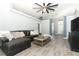 Spacious living room with a comfortable leather sectional, neutral decor, and plenty of natural light at 3200 Town And Country Rd, Oviedo, FL 32766