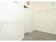 Bright walk-in closet with gray wood-look tile flooring and white walls with wire shelving, offering ample storage at 3200 Town And Country Rd, Oviedo, FL 32766