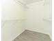 Walk-in closet with wire shelving and wood look flooring at 3200 Town And Country Rd, Oviedo, FL 32766
