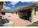 Backyard patio featuring outdoor kitchen, dining area, and stone water feature at 3285 Songbird Cir, Harmony, FL 34773