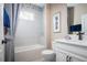 Bright bathroom featuring a shower-tub combo, white vanity, and modern fixtures at 3285 Songbird Cir, Harmony, FL 34773