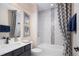 Well-lit bathroom with a shower-tub combo, modern fixtures, and tasteful decor at 3285 Songbird Cir, Harmony, FL 34773