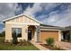 Charming single-Gathering home with neutral paint, stone accents, a two-car garage, and a well-manicured lawn at 3285 Songbird Cir, Harmony, FL 34773