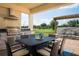Covered outdoor kitchen and dining area with built-in grill and stone waterfall feature for entertaining at 3285 Songbird Cir, Harmony, FL 34773