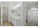 Bright bathroom featuring a double sink vanity with a shower and a connecting room at 343 Grand Royal Cir, Winter Garden, FL 34787