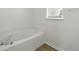 Relaxing soaking tub next to a window, set against a clean white bathroom at 343 Grand Royal Cir, Winter Garden, FL 34787