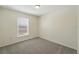 This is a cozy carpeted bedroom featuring a window with natural light at 343 Grand Royal Cir, Winter Garden, FL 34787