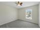 An empty bedroom offering neutral carpet, white walls, a ceiling fan, and a window at 343 Grand Royal Cir, Winter Garden, FL 34787
