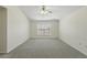 Carpeted bedroom with a ceiling fan and window offering natural light at 343 Grand Royal Cir, Winter Garden, FL 34787