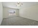 Carpeted bedroom featuring a ceiling fan and large window at 343 Grand Royal Cir, Winter Garden, FL 34787