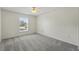 An empty bedroom offering neutral carpet, white walls, a ceiling fan, and a window at 343 Grand Royal Cir, Winter Garden, FL 34787