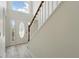 Bright foyer with tile flooring, staircase, and a front door with decorative glass at 343 Grand Royal Cir, Winter Garden, FL 34787