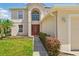 Inviting front entrance featuring a bright red door and manicured shrubs at 343 Grand Royal Cir, Winter Garden, FL 34787