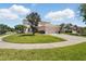 Well-manicured lawn and landscaping surround this charming home on a corner lot at 343 Grand Royal Cir, Winter Garden, FL 34787