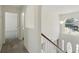 Bright hallway featuring white walls and railing with hardwood steps and multiple entryways at 343 Grand Royal Cir, Winter Garden, FL 34787