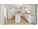 Spacious kitchen with an island, tile flooring, white appliances and ample storage at 343 Grand Royal Cir, Winter Garden, FL 34787