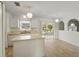 Functional kitchen with white cabinets, island, and sliding doors to the lanai at 343 Grand Royal Cir, Winter Garden, FL 34787
