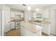 Bright kitchen featuring white cabinets, an island and tile floors at 343 Grand Royal Cir, Winter Garden, FL 34787
