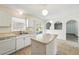 Bright kitchen featuring an island, white appliances, tile floor and access to lanai at 343 Grand Royal Cir, Winter Garden, FL 34787