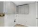Functional laundry room featuring tile floors and practical overhead cabinetry at 343 Grand Royal Cir, Winter Garden, FL 34787