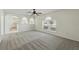 Spacious carpeted living room featuring a ceiling fan, archways and windows at 343 Grand Royal Cir, Winter Garden, FL 34787
