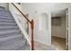 Carpeted staircase with white banister and wood handrail leads to the upper level at 343 Grand Royal Cir, Winter Garden, FL 34787