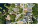 An aerial view of a neighborhood showcases well-maintained homes, mature trees, and sparkling swimming pools at 3535 Lake Sarah Dr, Orlando, FL 32804