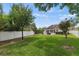 Expansive backyard with well-maintained grass, white privacy fence, and view of the home and pool at 3535 Lake Sarah Dr, Orlando, FL 32804