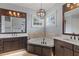 Spacious bathroom with a jetted tub, and vanities, and elegant fixtures under a unique chandelier at 3535 Lake Sarah Dr, Orlando, FL 32804