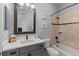 Bathroom featuring a tub and shower combo, a large mirror, and a gray vanity at 3535 Lake Sarah Dr, Orlando, FL 32804